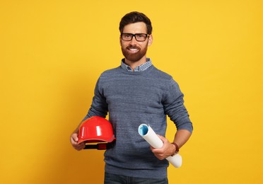 Photo of Professional engineer with hard hat and draft on yellow background