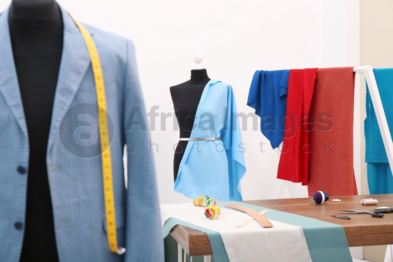 Photo of Mannequin with blue cloth in tailor studio