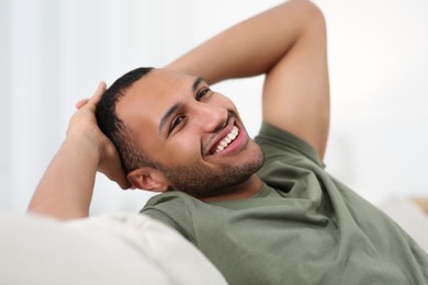 Photo of Portrait of smiling African American man on sofa at home