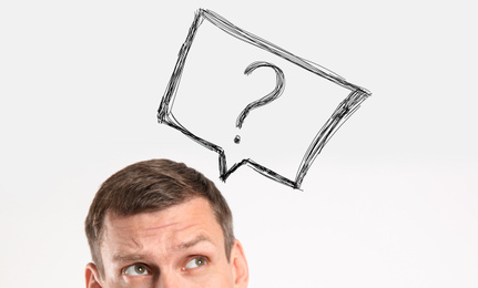 Emotional man with drawing of question mark on white background