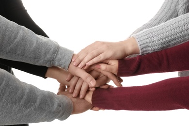 Young people putting their hands together on white background, closeup