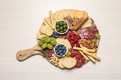 Tasty parmesan cheese and other different appetizers on white wooden table, top view