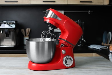 Photo of Modern stand mixer on wooden table in kitchen. Home appliance