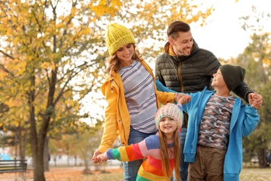 Photo of Happy family with children together in park. Autumn walk