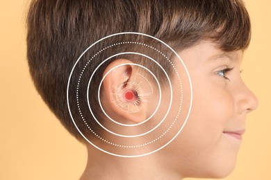 Cute little boy with hearing problem on color background, closeup