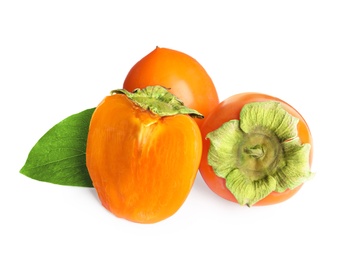 Delicious cut and whole persimmons isolated on white