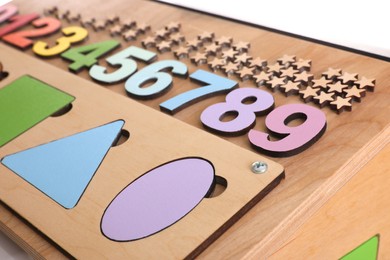 Closeup view of busy board on white background. Baby sensory toy
