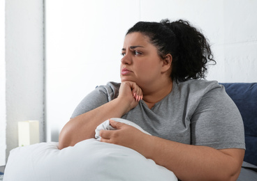 Overweight woman suffering from depression at home