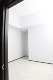 Photo of Blurred view of empty office room with white walls. Interior design