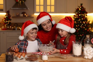 Photo of Happy family making dough for Christmas cookies at home