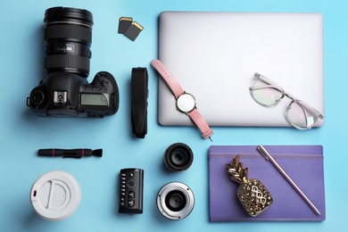 Flat lay composition with photographer's equipment and accessories on color background