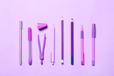 Photo of Flat lay composition with different school stationery on violet background