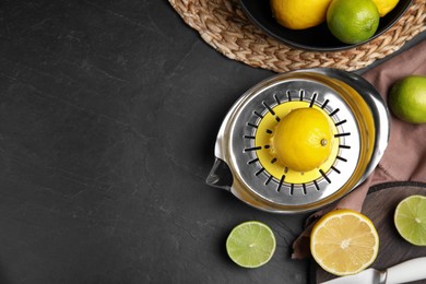 Photo of Squeezer, fresh lemons and limes on black table, flat lay. Space for text