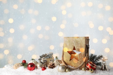 Composition with wooden Christmas lantern on snow, space for text. Bokeh effect