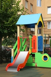 Photo of Empty outdoor children's playground with slide in residential area