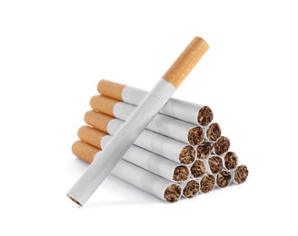 Pile of cigarettes with orange filters on white background