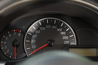 Speedometer and tachometer on modern car dashboard