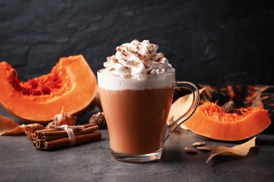 Delicious pumpkin latte on grey table, closeup