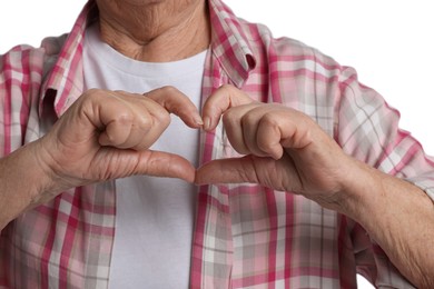 Elderly woman making heart with her hands on white background, closeup