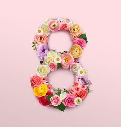 International women's day. Number 8 made of beautiful flowers on pale pink background, top view