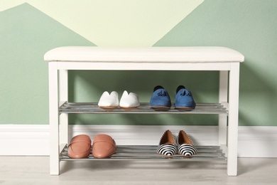 Photo of Storage bench with different female shoes indoors