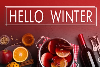 Greeting card with text Hello Winter. Delicious mulled wine and ingredients on table, flat lay