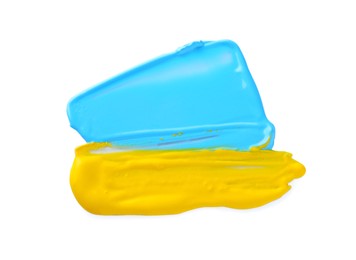 Light blue and yellow paint samples on white background, top view