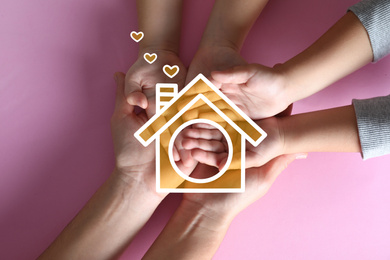 Illustration of house and happy family holding hands on pink background, top view