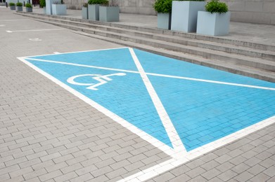 Photo of Car parking lot with wheelchair symbol outdoors