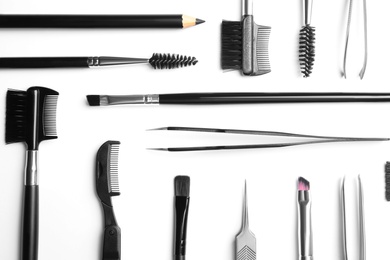 Set of professional eyebrow tools on white background, top view