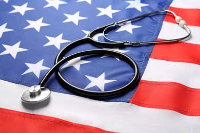 Photo of Closeup view of stethoscope on American flag