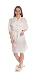 Young woman in silk robe on white background