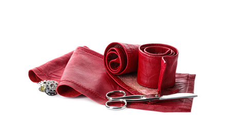 Red leather samples and craftsman tools isolated on white