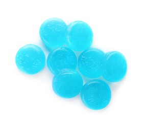 Many light blue cough drops on white background, top view