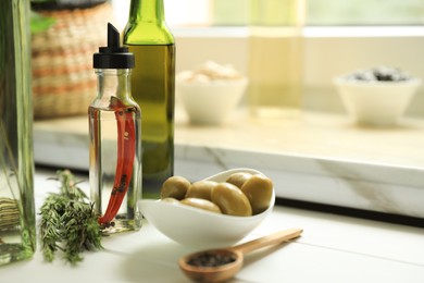 Different cooking oils and ingredients on white wooden table indoors