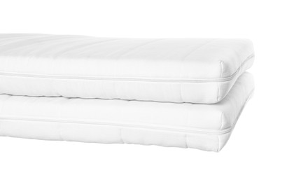 Photo of Two new comfortable mattresses isolated on white, closeup