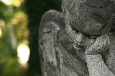Beautiful statue of angel outdoors, closeup with space for text. Funeral ceremony