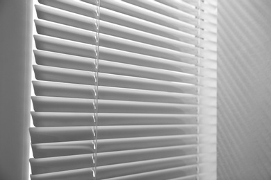 Closeup view of window with closed horizontal blinds