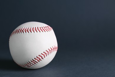Photo of Baseball ball on dark background, closeup with space for text. Sports game
