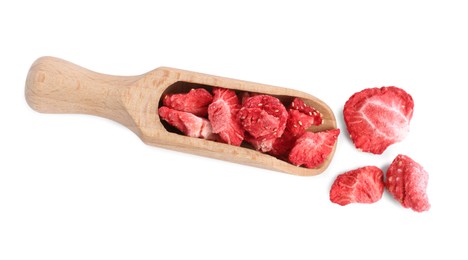 Photo of Wooden scoop with freeze dried strawberries on white background, top view