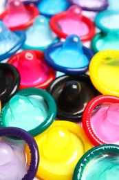 Unpacked colorful condoms as background, closeup. Safe sex