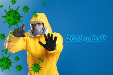 Man in chemical protective suit holding test tube of blood sample on blue background. Virus research