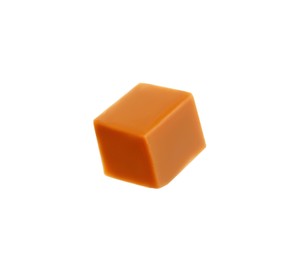 One caramel cube isolated on white. Confectionery