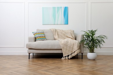Modern living room with parquet flooring and stylish sofa