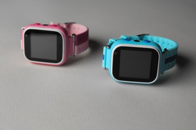 Modern trendy smart watches for kids on grey background