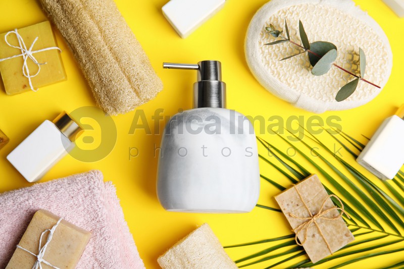 Flat lay composition with marble soap dispenser on yellow background