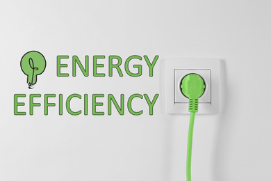 Energy efficiency concept. Power socket and plug on white background