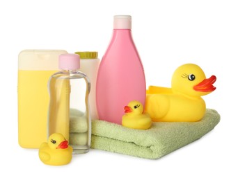 Photo of Set of baby cosmetic products, towel and rubber ducks on white background