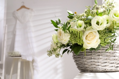 Basket with beautiful wedding flowers on window sill indoors, closeup