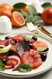 Photo of Plate of delicious sicilian orange salad on grey table, closeup. Space for text
